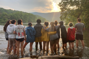 Camp Horizons leadership campers view the sunset on a canoe trip.